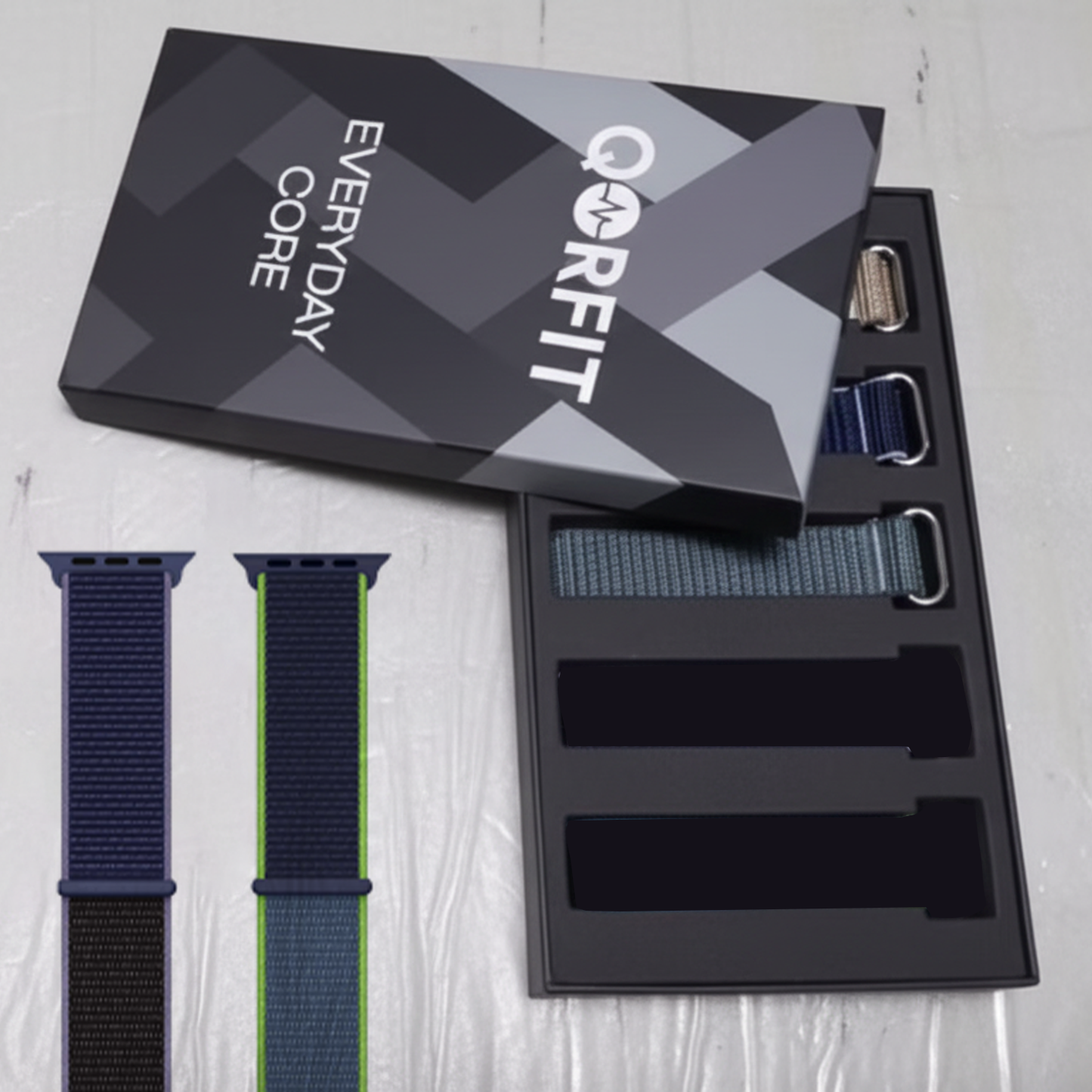 Qorfit fitness and health tracker straps packaging with straps displayed on a light gray surface