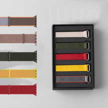 A set of health tracker straps, displayed with a black box containing additional bright color straps on a light gray background.